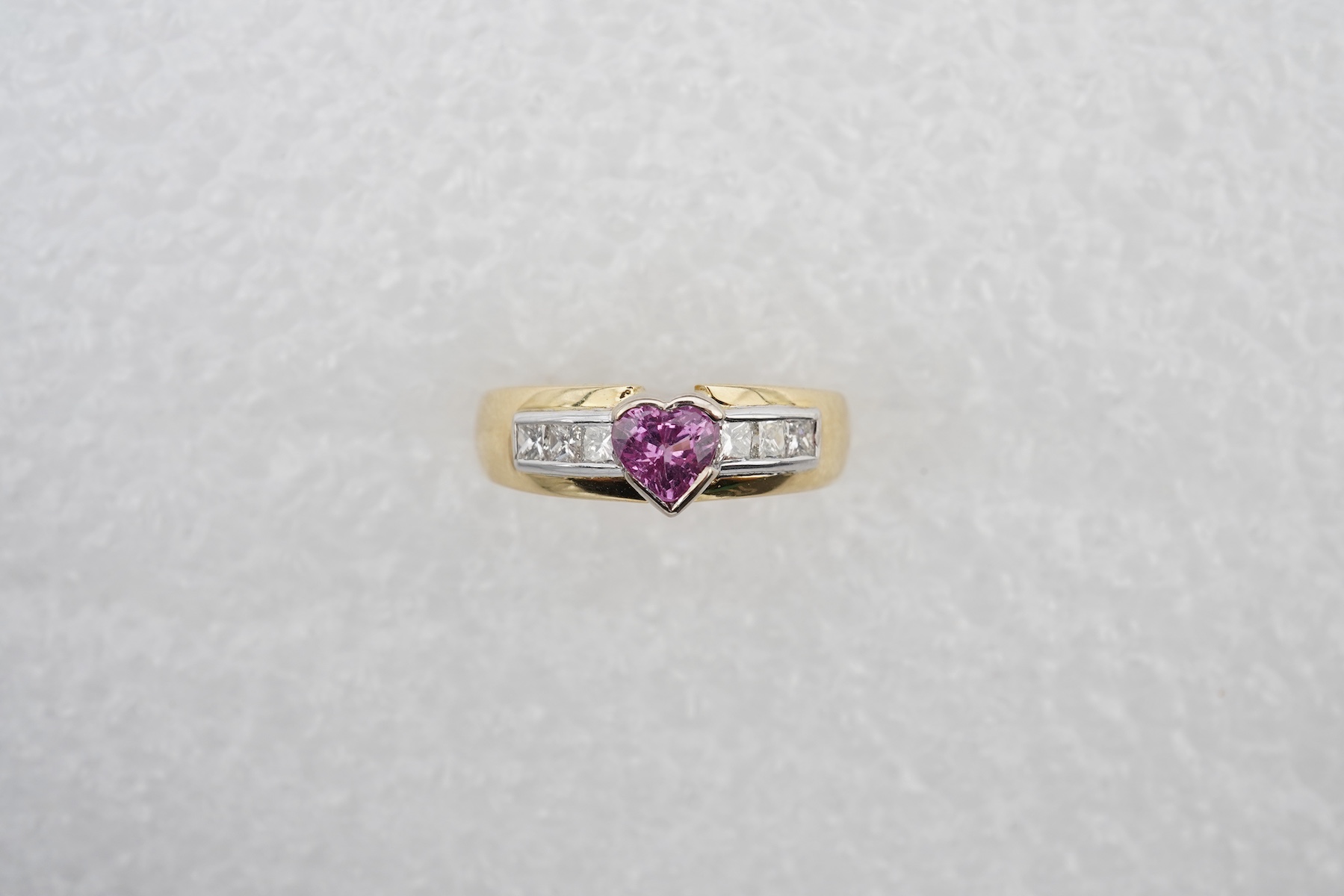 A pink sapphire and diamond ring